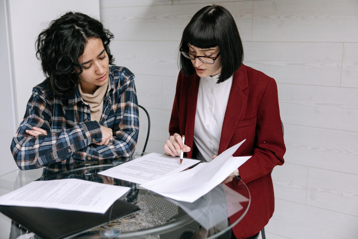Two colleagues reviewing documents together at a table