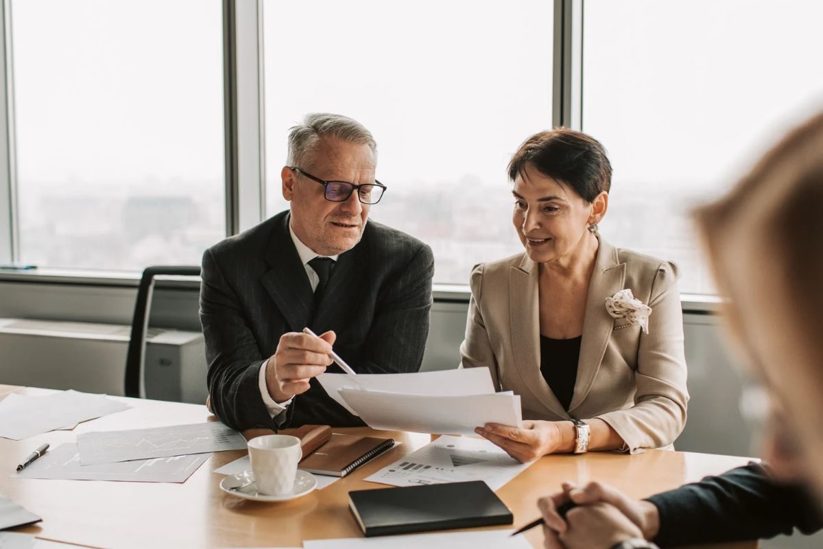 Advisor reviewing documents with a client at a table